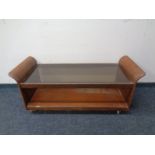 A mid 20th century G-Plan teak two tier coffee table on castors with smoked glass inset.