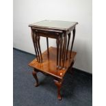 A nest of three tables with tooled leather inset panels together with a further contemporary lamp