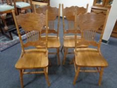A set of four American style dining chairs.