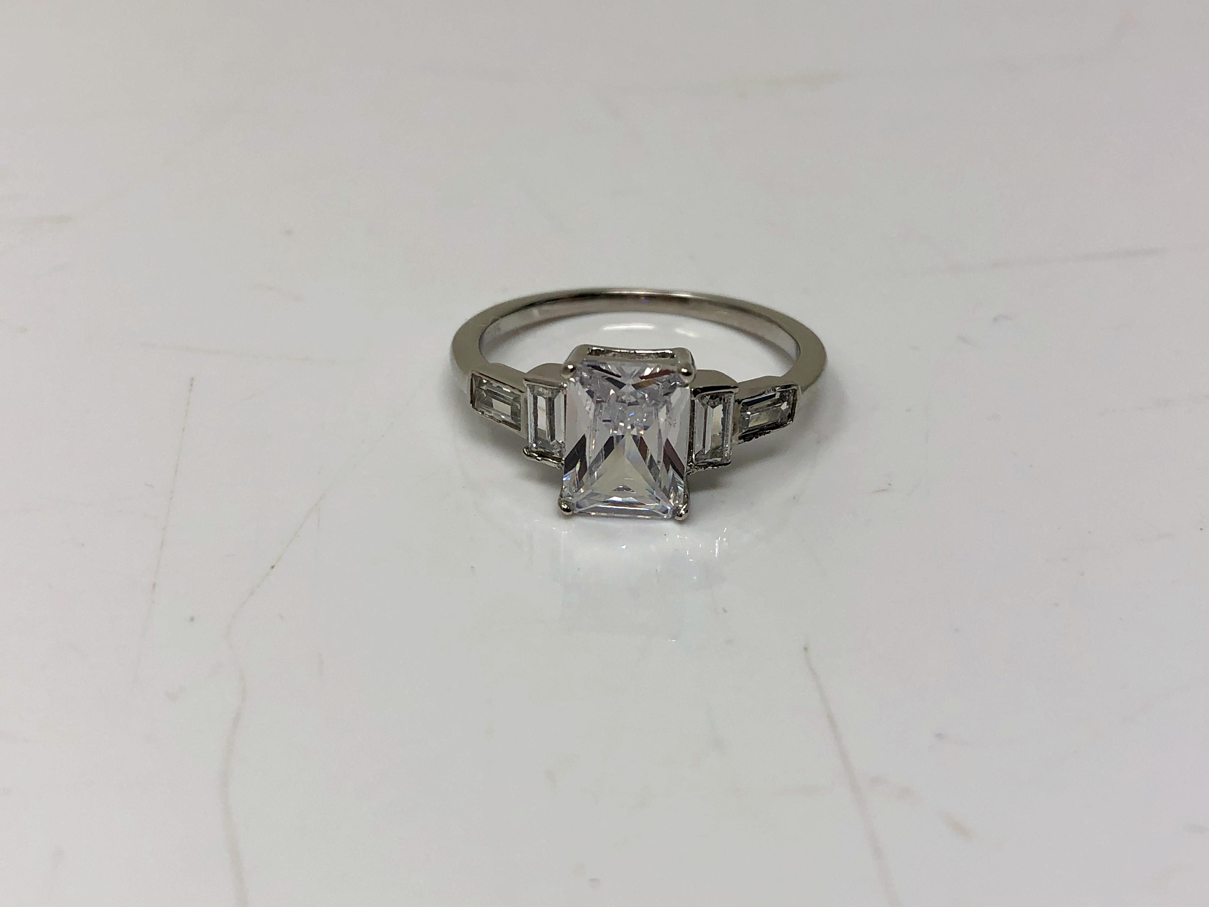 An Art Deco style emerald cut sterling silver ring, size N.