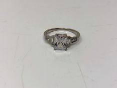 An Art Deco style emerald cut sterling silver ring, size N.