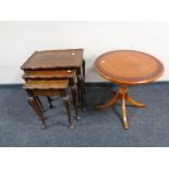 A nest of three walnut pie crust edge tables together with an inlaid yew wood wine table