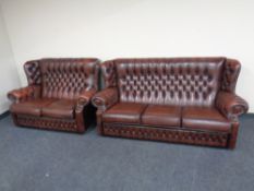 A brown buttoned leather Chesterfield three seater wingback settee with matching two seater settee.