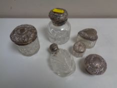 Five cut glass silver topped dressing table jars and scent bottles,