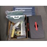 A box of assorted tools, hardware, face masks, gazebo panels,