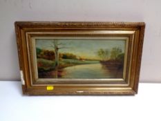 An antiquarian oil on board depicting figures by a river with dwelling beyond,