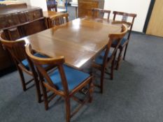 An eight piece 20th century carved oak dining room suite comprising of shaped front sideboard,