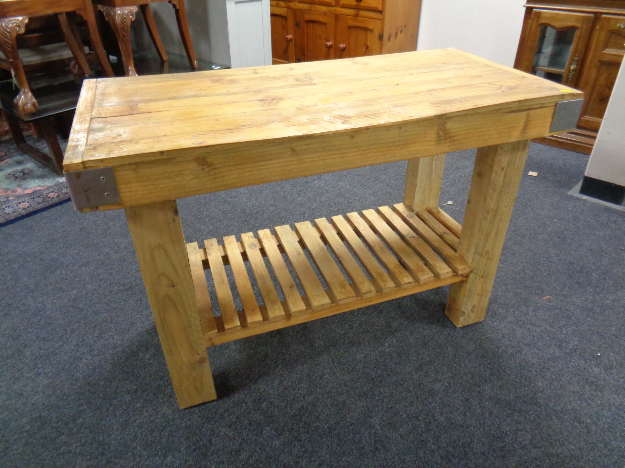 A reclaimed pine butcher's block kitchen table with undershelf.