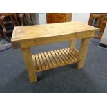 A reclaimed pine butcher's block kitchen table with undershelf.