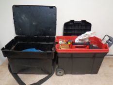 A large plastic fishing box and a tool box on wheels containing fishing equipment to include lures,