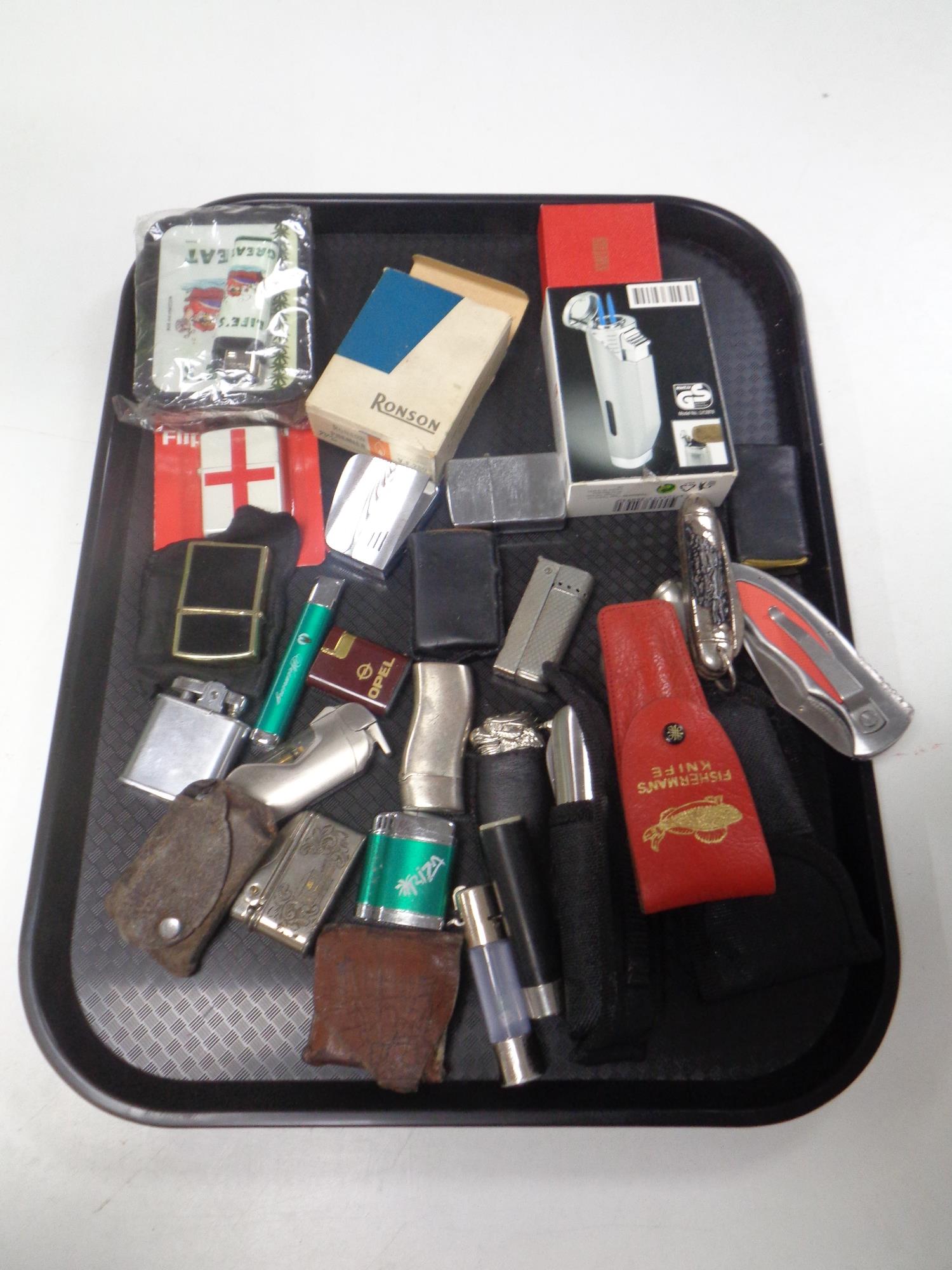 A tray of a large quantity of assorted pocket lighters, knives,