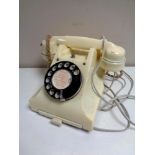 A white Bakelite cased GPO telephone.