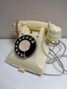 A white Bakelite cased GPO telephone.