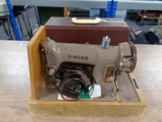 A 20th century cased Singer electric sewing machine.