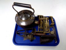 A tray of antique and later metal, brass trivets, copper kettle, flat iron on stand,