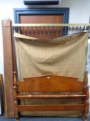 An Edwardian 5' stained beech bed frame with box spring.