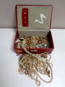 A red leather jewellery box containing costume jewellery to include rings, earrings, brooches,