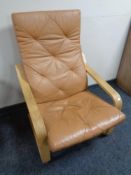 An Ikea armchair with brown leather cushion