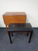 A gateleg table together with an organ stool.