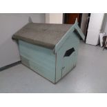 A large dog kennel with felt roof.