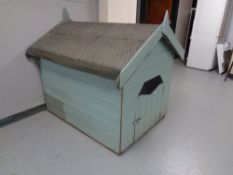 A large dog kennel with felt roof.