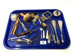 A tray containing vintage corkscrews, silver handled shoe horns and button hooks, cutlery,