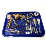 A tray containing vintage corkscrews, silver handled shoe horns and button hooks, cutlery,