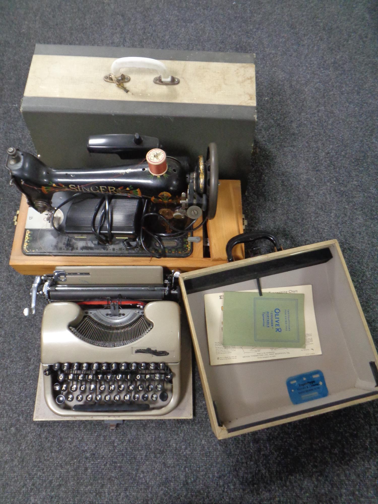 A vintage cased typewriter together with a 20th century cased Singer electric sewing machine.