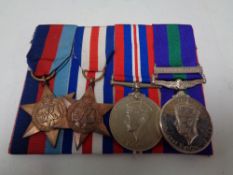 A group of four WWII medals to include campaign medal, Palestine Medal,