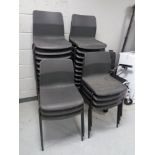 A set of twenty seven black plastic stacking chairs