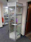 A hexagonal shop display cabinet with circular shelves.