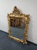 An ornate Victorian style gilt framed wall mirror (af)