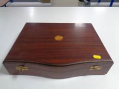 An Edwardian inlaid mahogany canteen containing stainless steel cutlery.