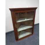 A nineteenth century glazed door hanging corner cabinet