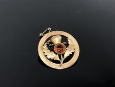 A circular gold thistle brooch, indistinctly stamped. CONDITION REPORT: 4.