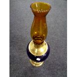 A Duplex brass and porcelain oil lamp with amber glass chimney