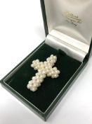 A pearl crucifix pendant