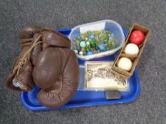 A box of miscellany to include pair of vintage boxing gloves, boxed billiard balls,