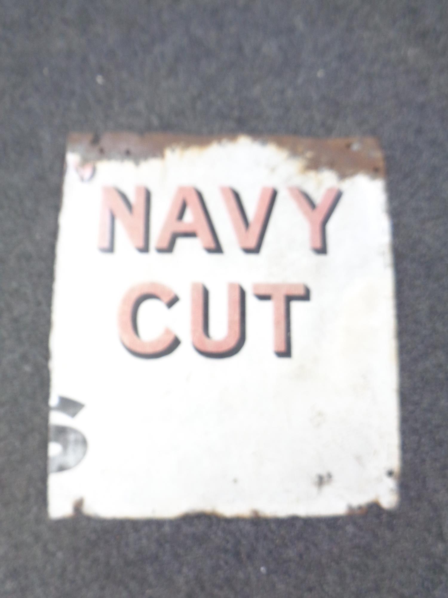 A part enamelled sign bearing Navy Cut advertisement.