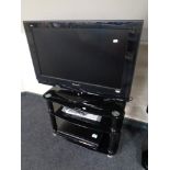 A Panasonic Viera 32" LCD TV on stand with remote, together with a Panasonic DVD recorder.