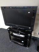 A Panasonic Viera 32" LCD TV on stand with remote, together with a Panasonic DVD recorder.