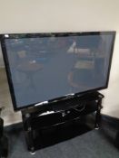 A Panasonic 50" plasma TV with remote on stand.