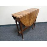 A 19th century walnut drop leaf occasional table.