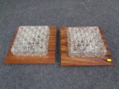 Two mid 20th century wall lights mounted on rosewood effect boards.