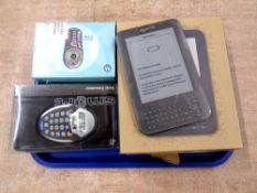 A tray of Amazon kindle boxed, smart solar calculator boxed, Motorola C115 mobile phone boxed.