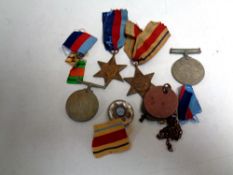 A tin containing World War II medals to include the War and Defence medal, the African Star,