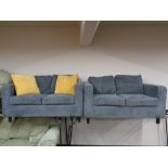 A pair of contemporary two seater settees upholstered in a blue corded fabric.