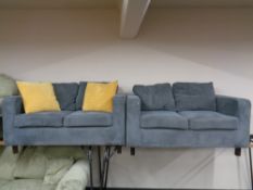 A pair of contemporary two seater settees upholstered in a blue corded fabric.