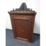 A George III inlaid oak corner cabinet