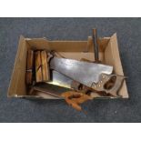 A box containing vintage woodworking planes, hand saws, wooden mallet etc.